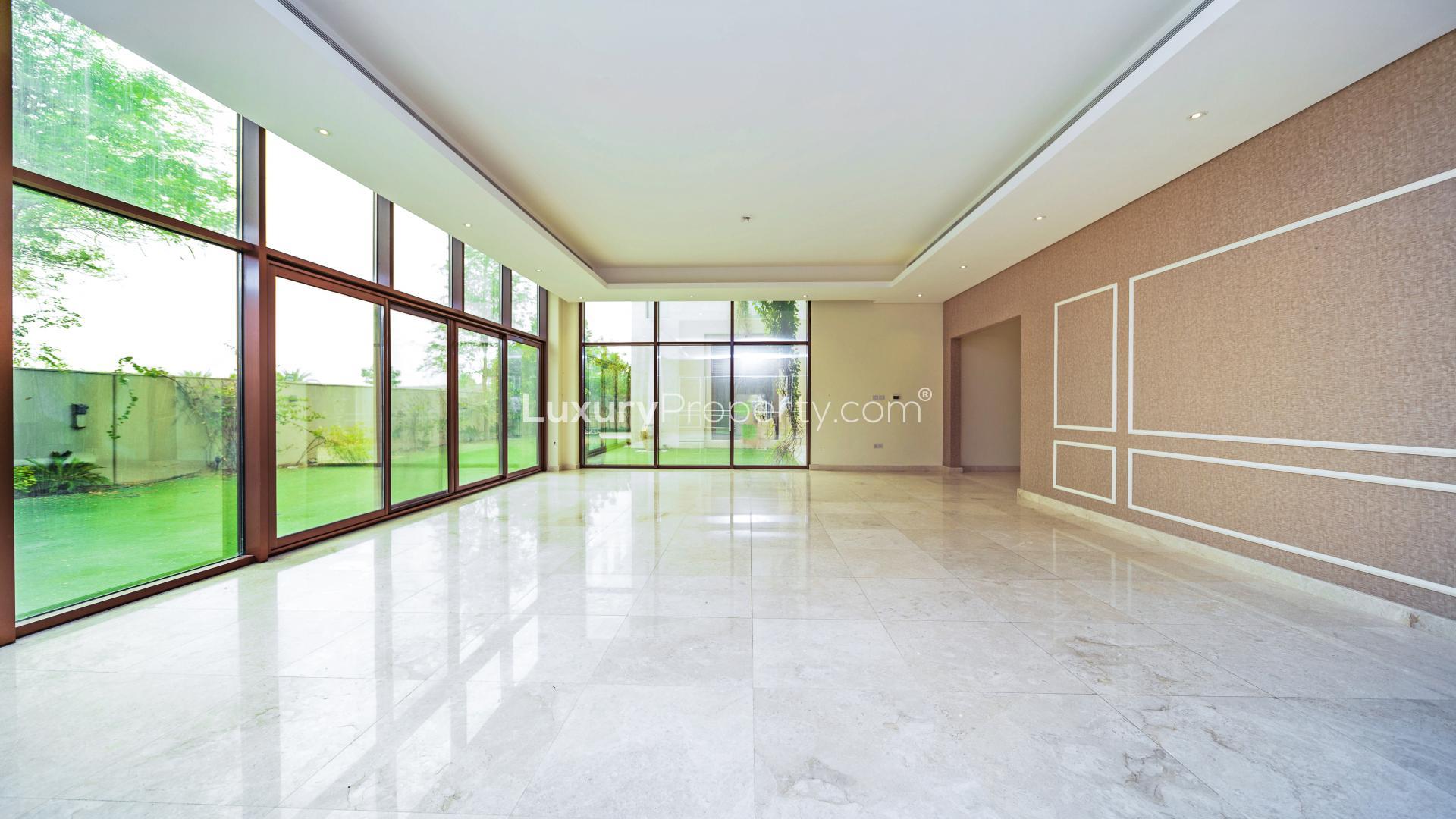 Stunning villa exterior with lush green lawn in Meydan Gated Community, Dubai