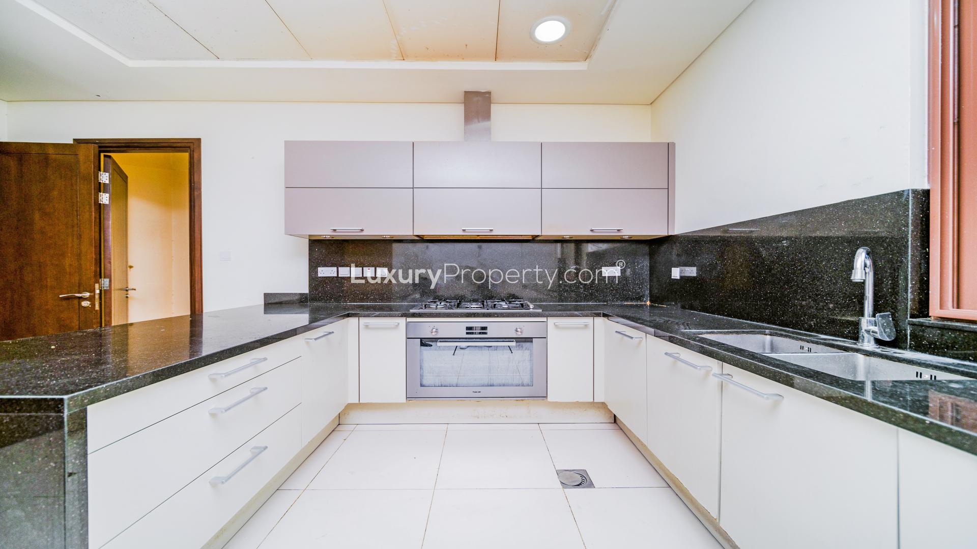 Spacious living room in 5-bedroom Meydan villa for rent, featuring modern design and large windows