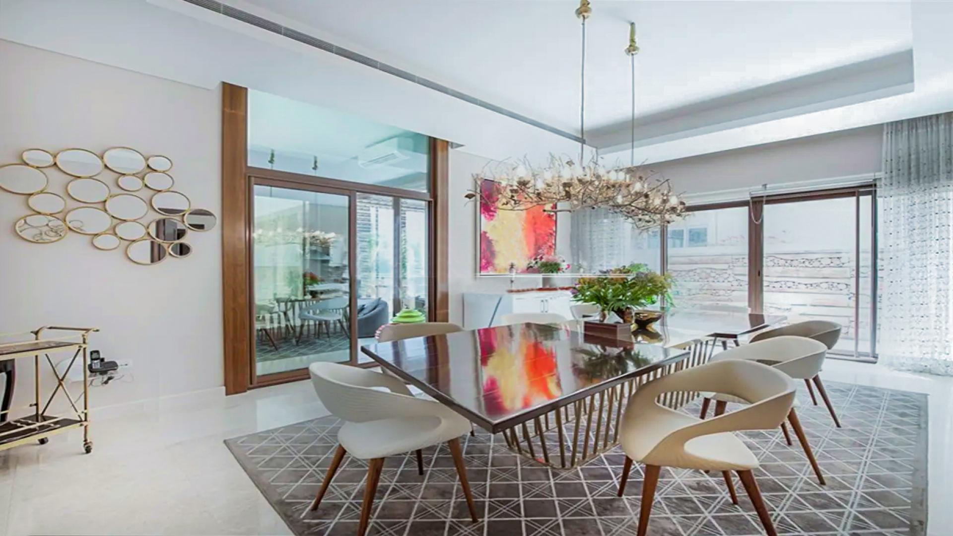 Outdoor patio with lush greenery at Meydan Gated Community villa, Millennium Estates