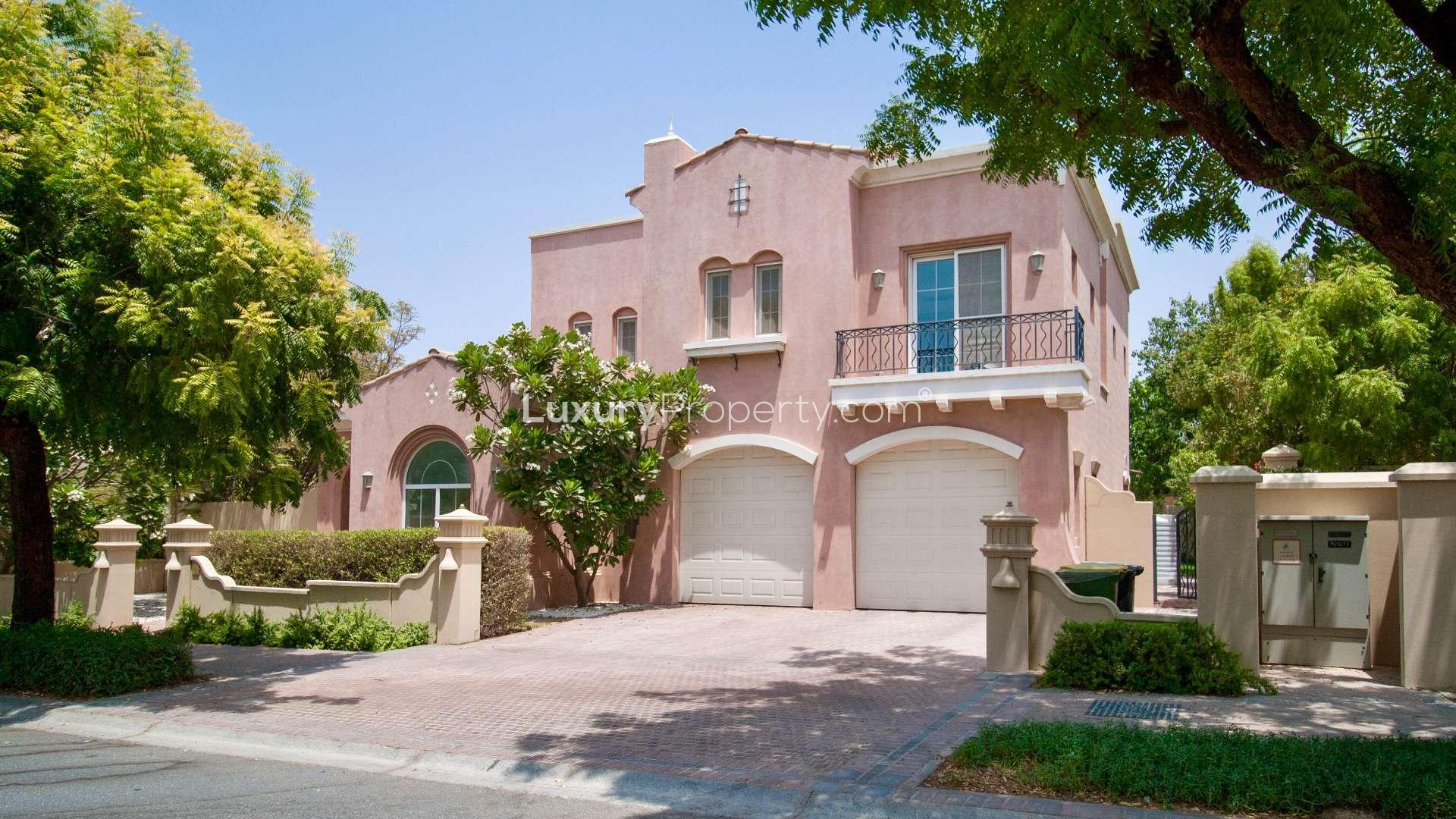 Large 5-bedroom villa exterior in Mirador, Arabian Ranches, with spacious driveway and lush greenery