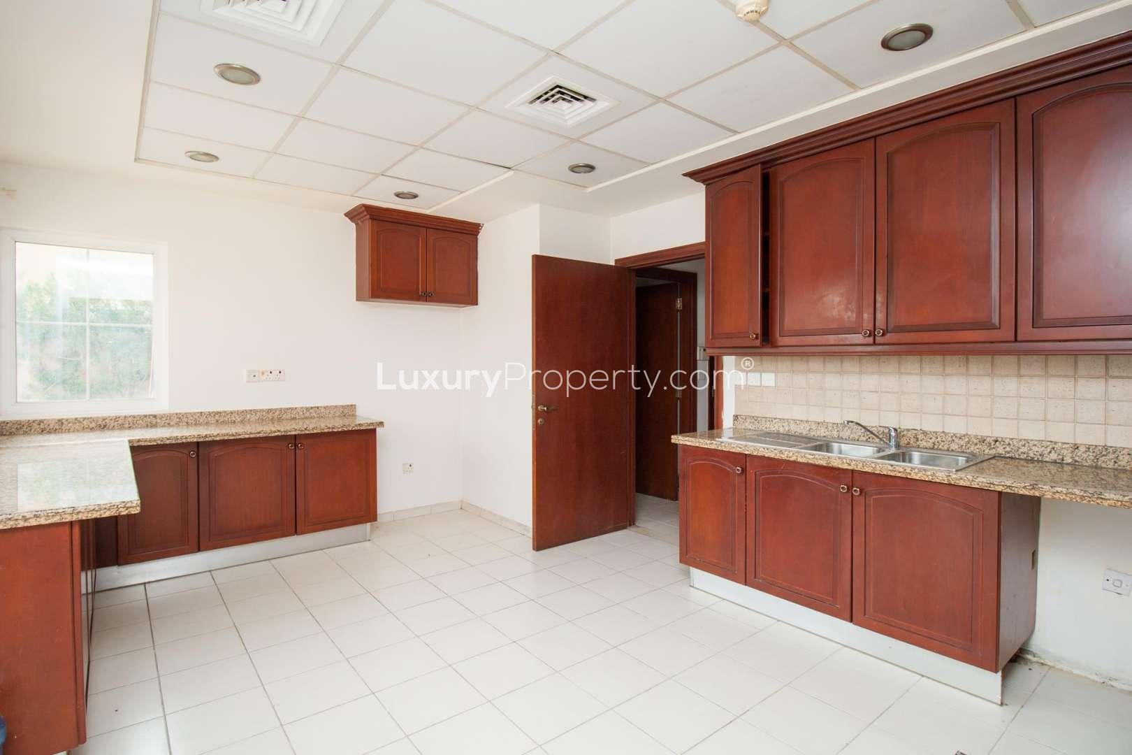 Spacious kitchen with wooden cabinets in Mirador La Coleccion villa, Arabian Ranches for rent