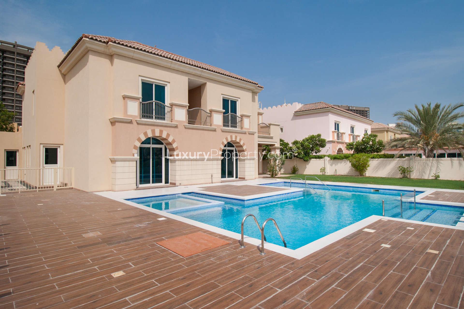 Villa exterior in Victory Heights, Dubai Sports City, with landscaped garden and gated entrance