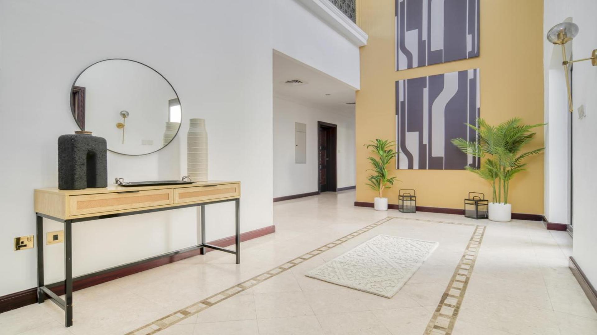 Luxury dining room in Palm Jumeirah villa with elegant furnishings and large windows