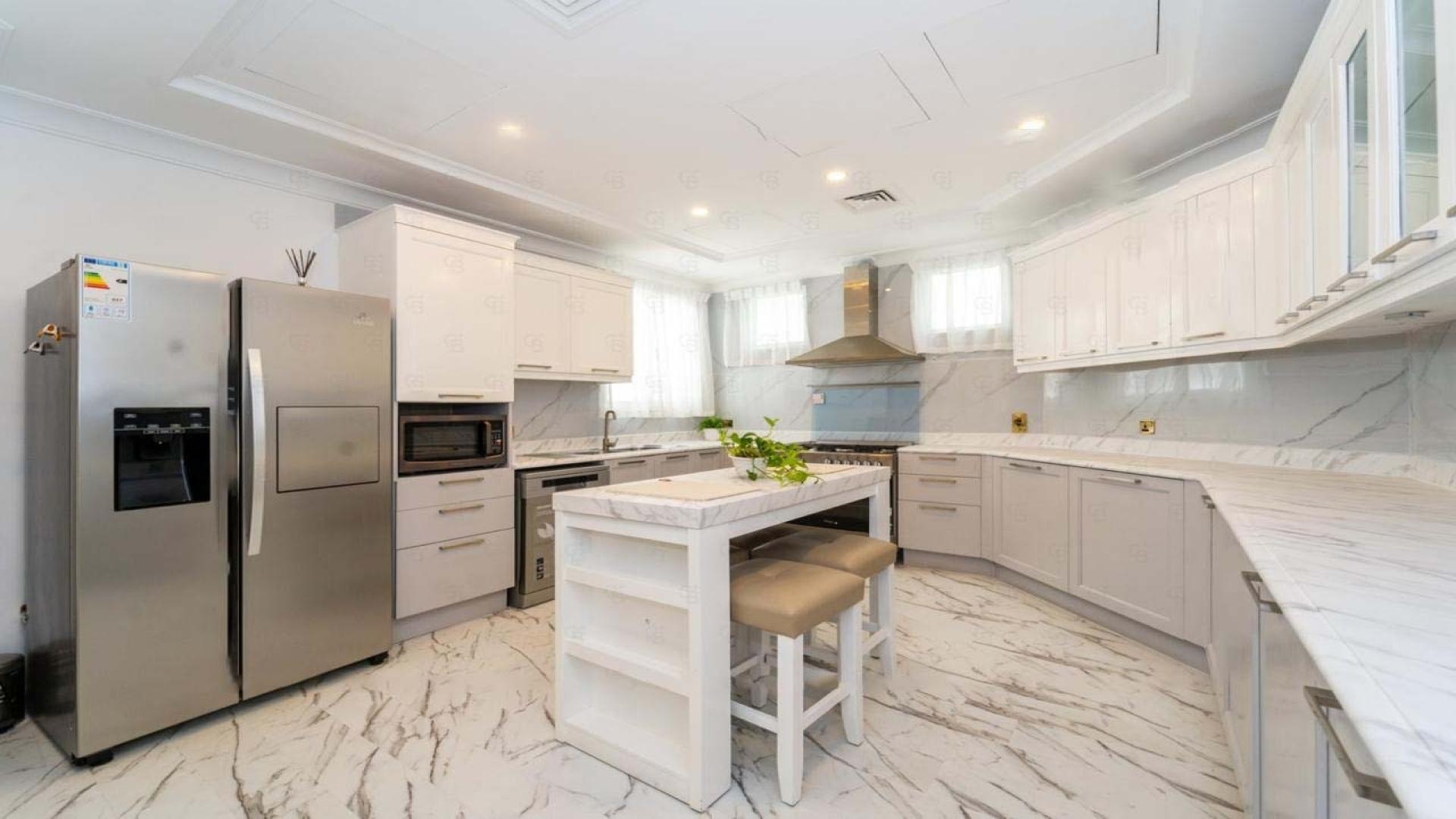 Furnished living room in Palm Jumeirah villa with modern decor and large windows