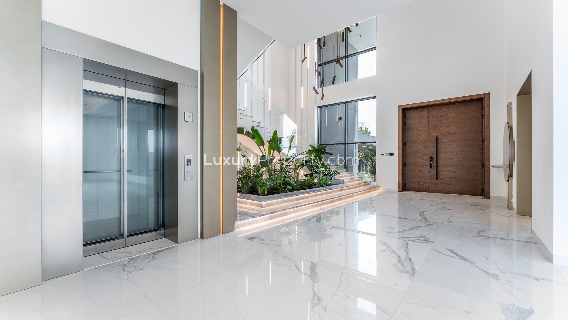 Luxurious open living area with marble floors and pool view in Dubai Hills Estate villa