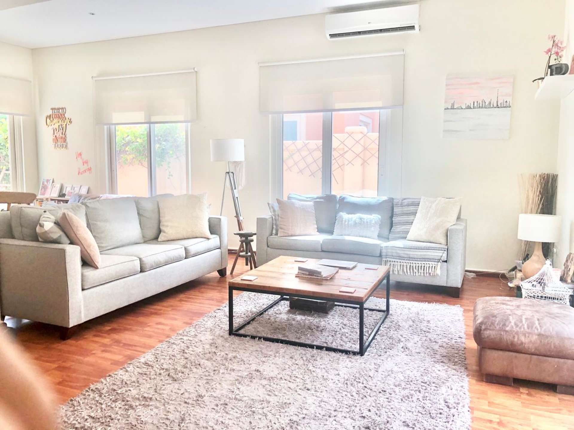 Living room with pool view in upgraded Victory Heights villa, Dubai Sports City