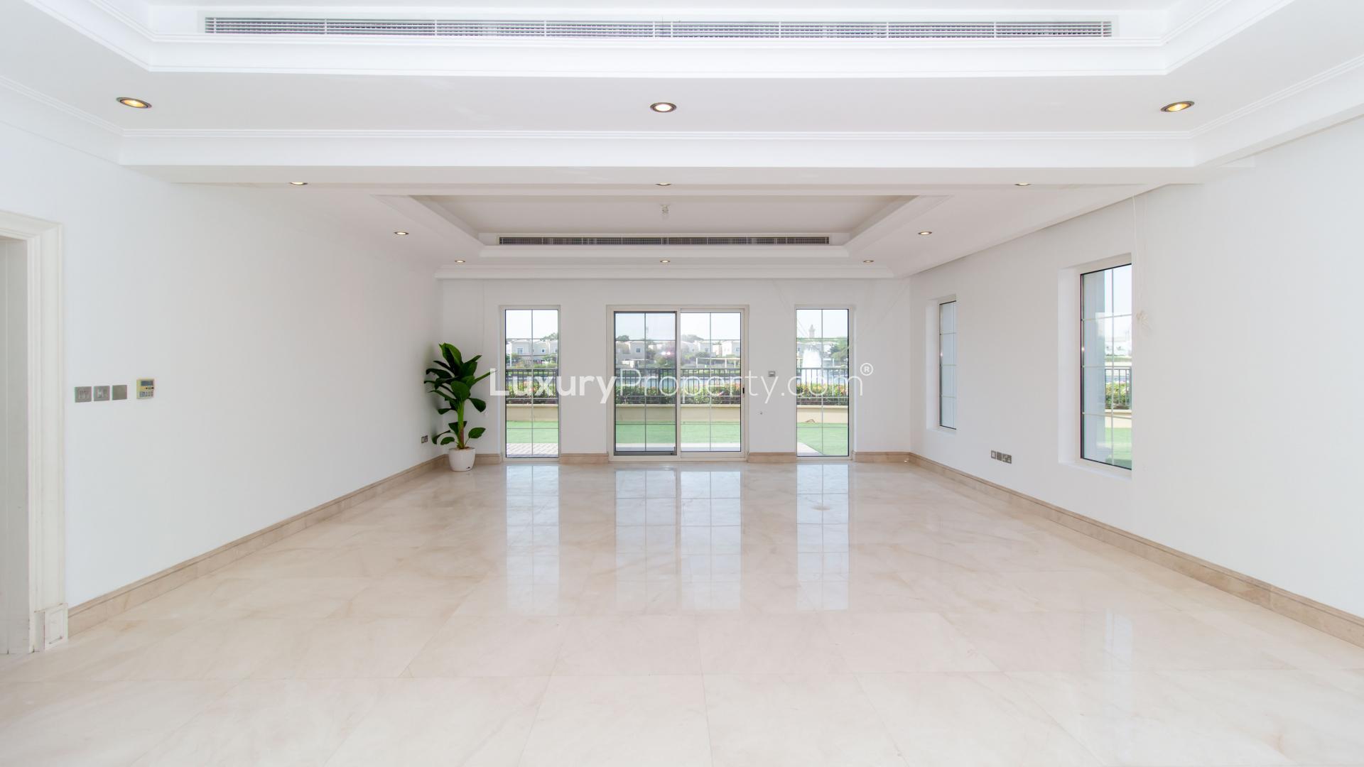 Luxury villa patio with green lawn in La Avenida, Arabian Ranches, available for rent