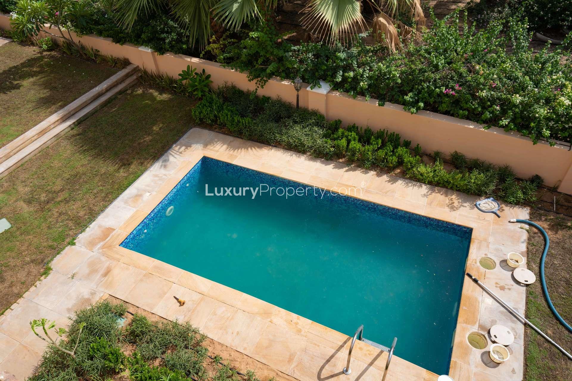 "Spacious kitchen in 5-bedroom Tuscan villa, Orange Lake, Jumeirah Golf Estates, for rent.",Private pool in Tuscan villa, Jumeirah Golf Estates, Orange Lake community, lush surroundings