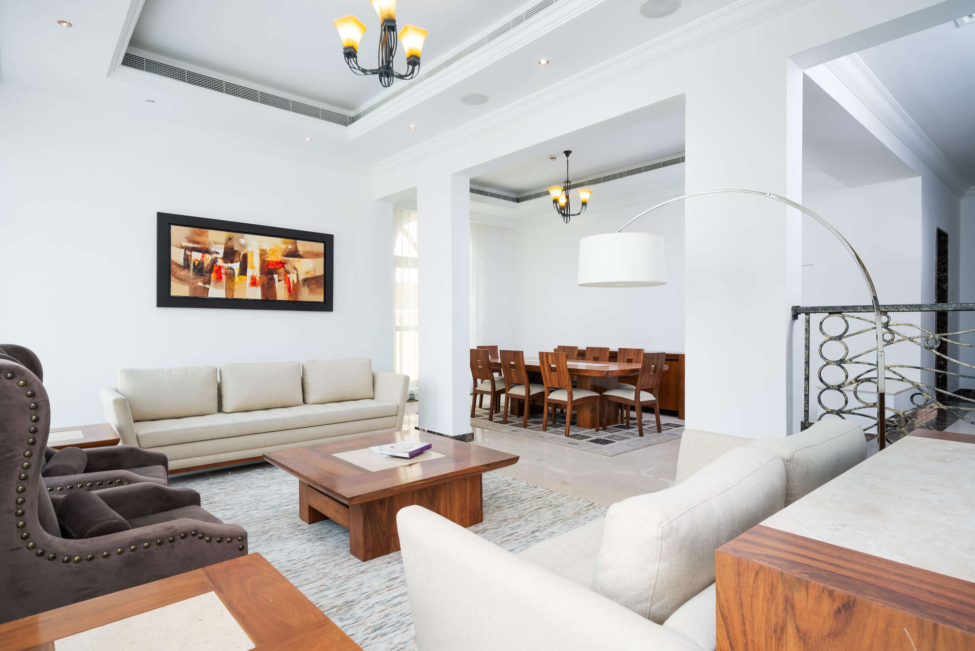 "Elegant 5-bedroom villa for sale in Jumeirah Golf Estates, Fire community, Dubai.",Elegant living and dining area in Jumeirah Golf Estates villa, featuring modern furnishings