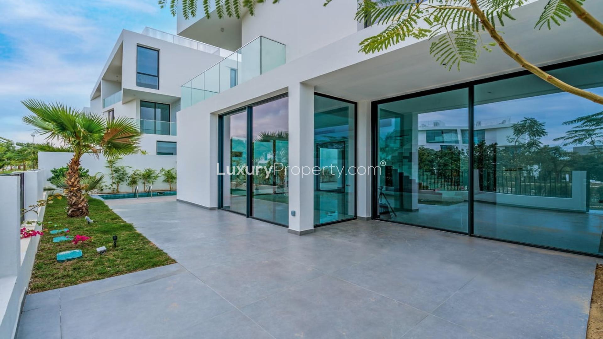 Spacious living room with large windows in modern Chorisia 2 villa, Al Barari