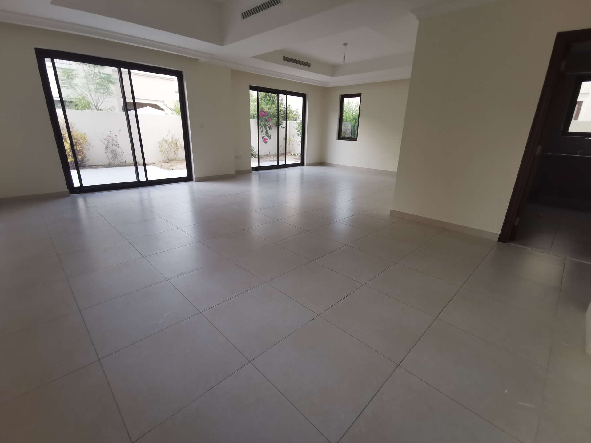 Empty room with large window and balcony in Arabian Ranches 2 villa, Dubai