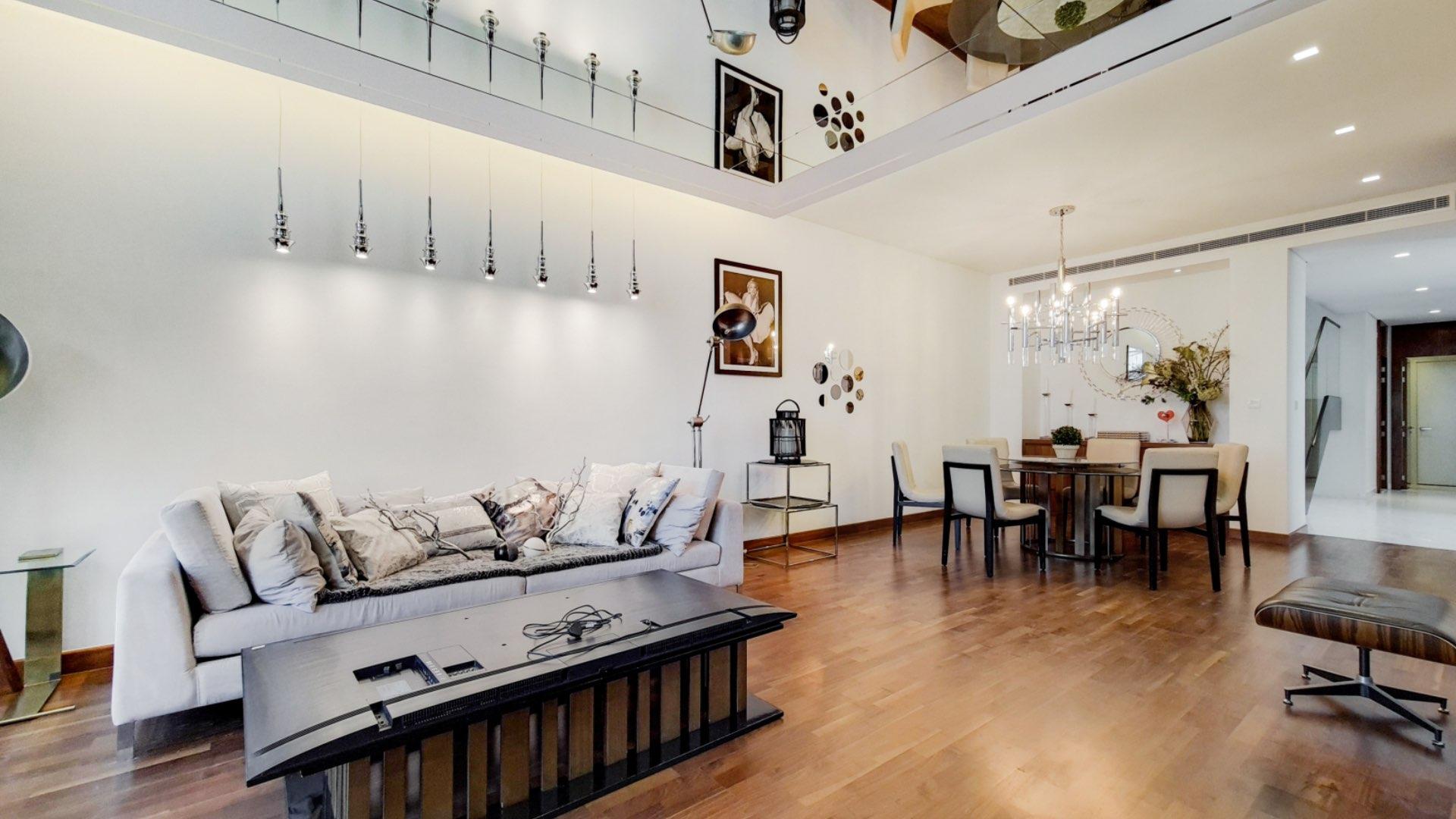 Elegant living and dining area in Paramount Villa, Damac Hills, with modern decor and lighting