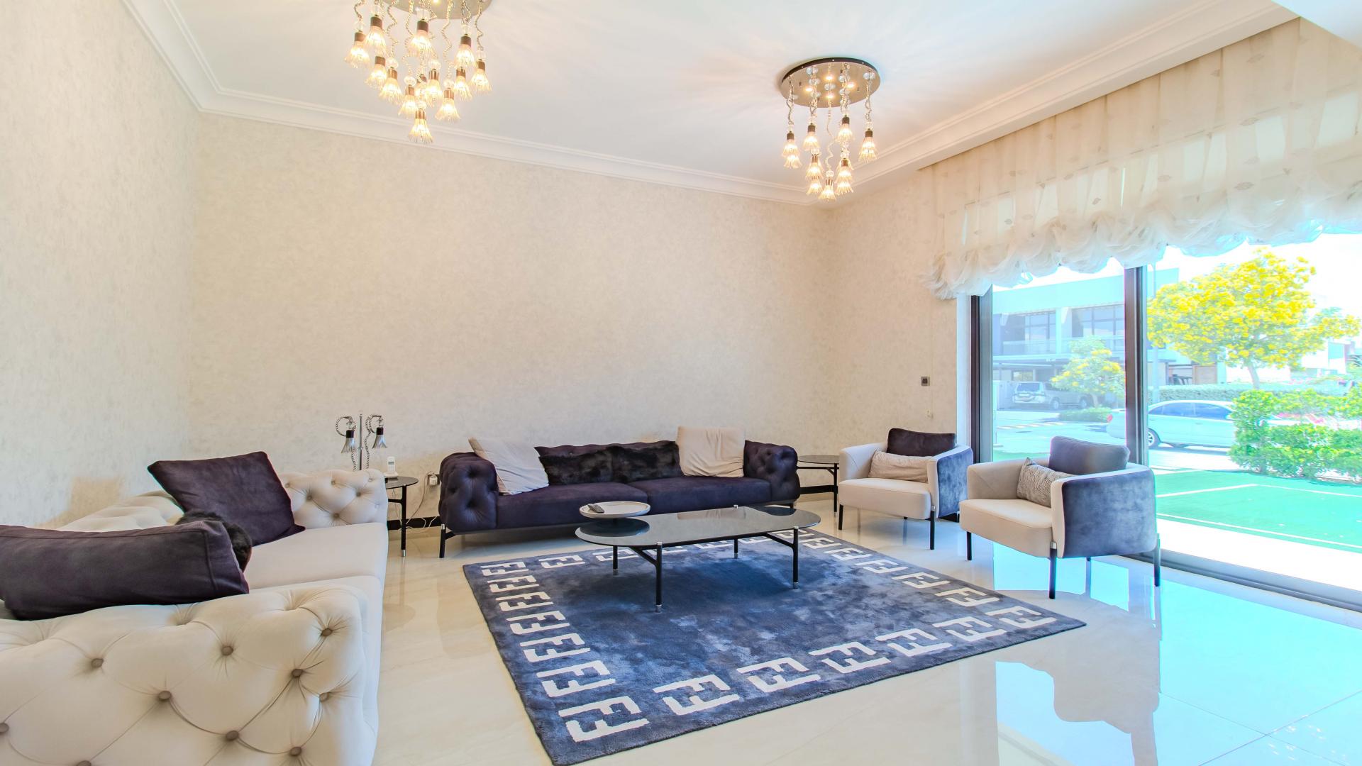 Modern kitchen in upgraded Flora villa, Damac Hills, featuring sleek cabinetry and dining area