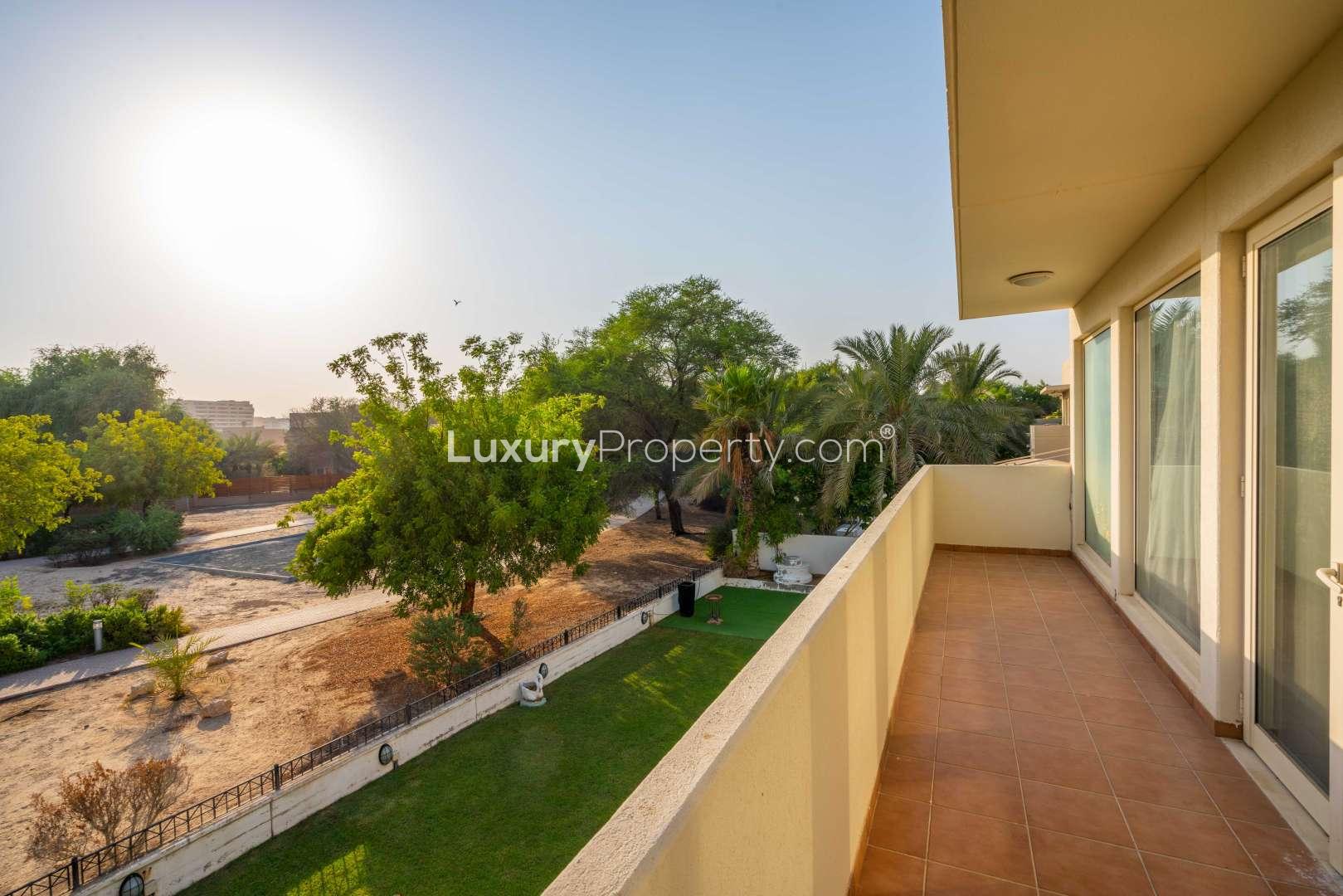 Dining room in Saheel 1 villa, Arabian Ranches, with elegant table and garden view