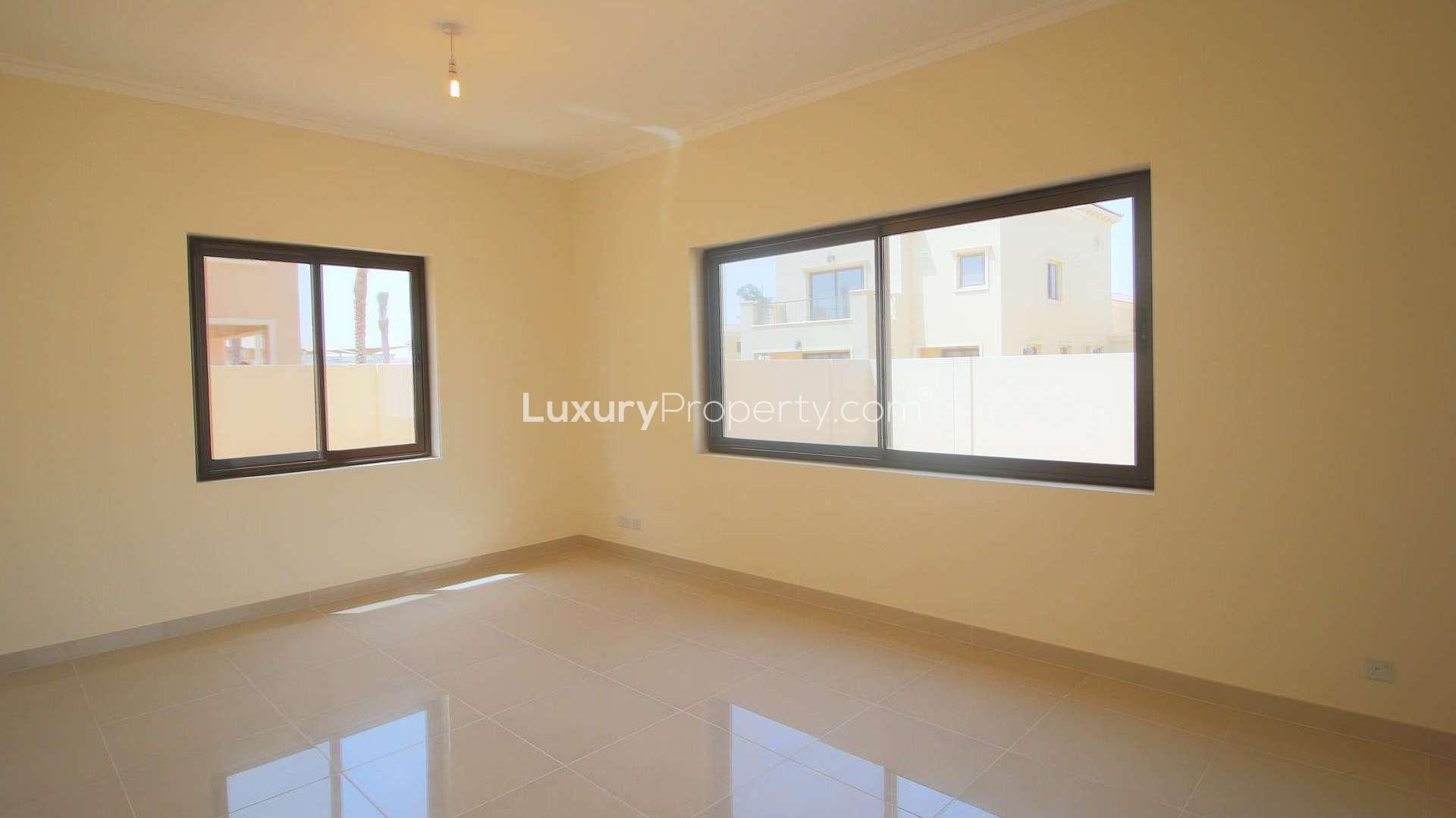 Bright living room in six-bedroom villa, Samara, Arabian Ranches 2, with large windows and patio