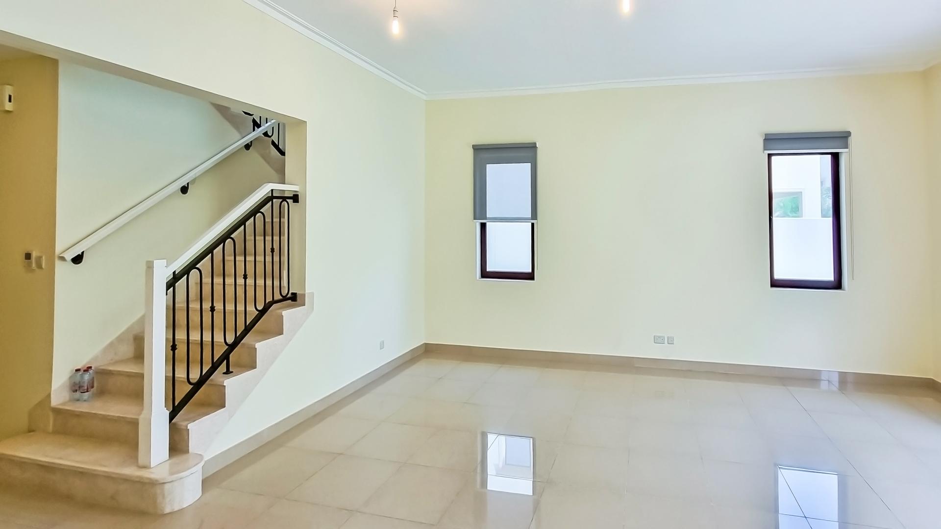 "Spacious living area in 5-bedroom villa, Samara, Arabian Ranches 2, ready to move in.",Spacious living room with staircase in Samara villa, Arabian Ranches 2, available for rent
