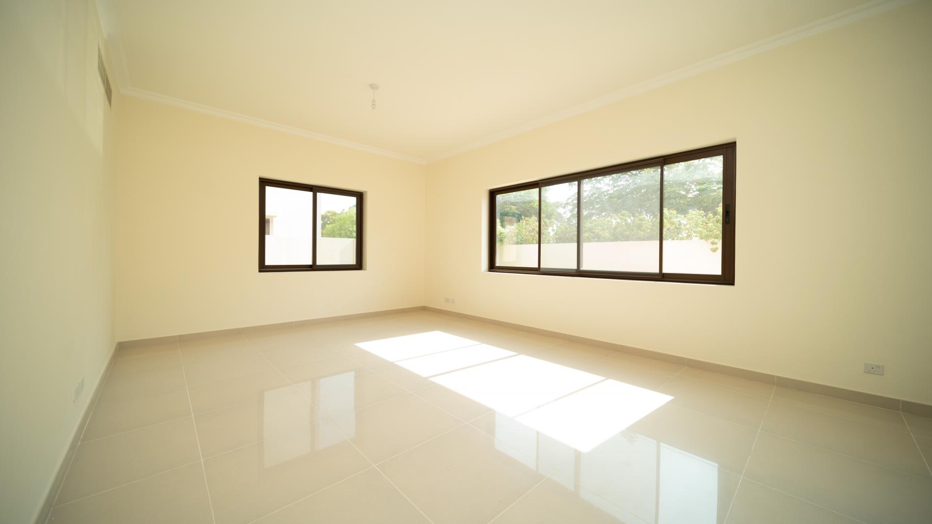 Bright living room in Samara villa, Arabian Ranches 2, with large windows and garden view