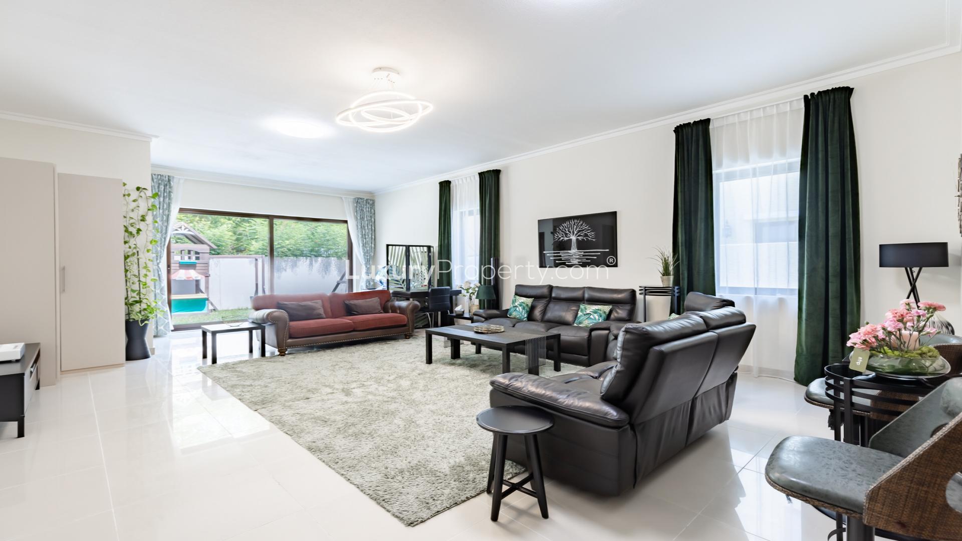Spacious living room in 5-bedroom villa, Samara, Arabian Ranches 2, with modern decor and garden view