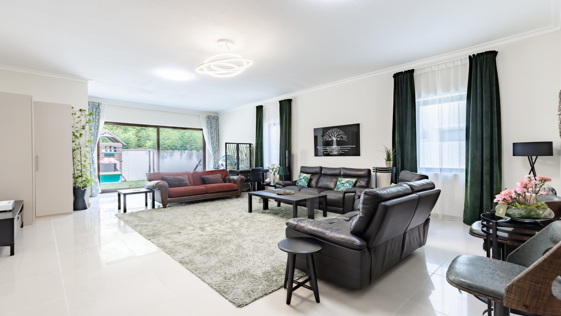 Spacious living room in 5-bedroom villa, Samara, Arabian Ranches 2, with modern decor and garden view