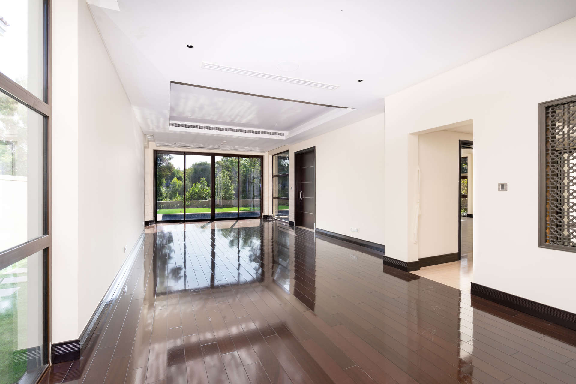 Luxurious villa interior with glass doors and pool view in Jumeirah Golf Estates