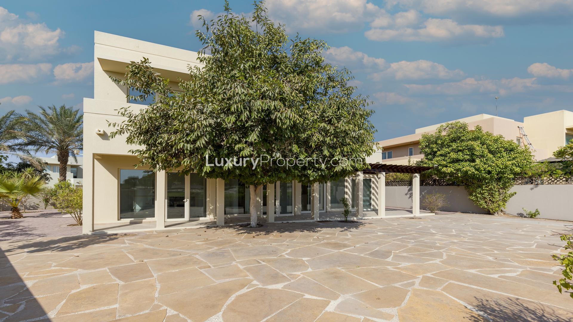 "Spacious villa patio with lush greenery in Arabian Ranches, Savannah community, for rent.",Entrance of spacious villa with garden in Arabian Ranches, Savannah community, for rent