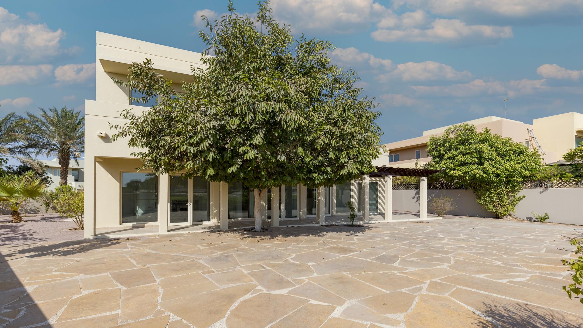 "Spacious villa patio with lush greenery in Arabian Ranches, Savannah community, for rent.",Entrance of spacious villa with garden in Arabian Ranches, Savannah community, for rent