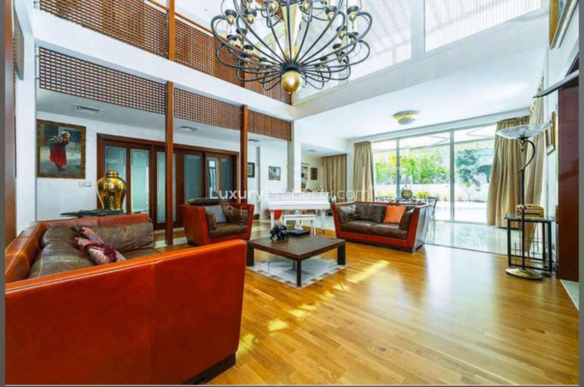 Modern kitchen in 5-bedroom Emirates Hills villa, featuring sleek cabinetry and vibrant lighting