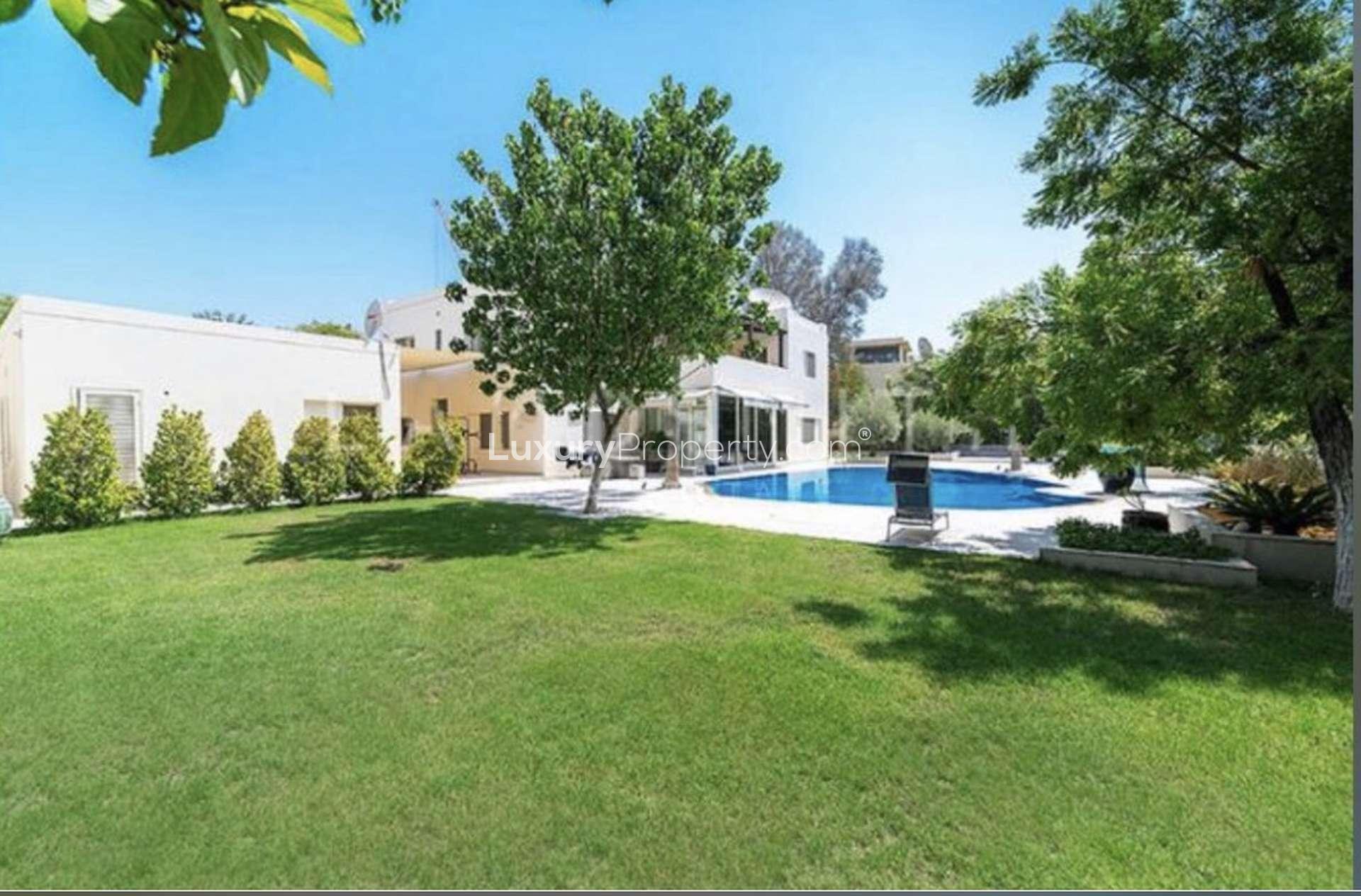 Luxurious living room in 5-bedroom villa, Emirates Hills, Sector E, featuring elegant decor