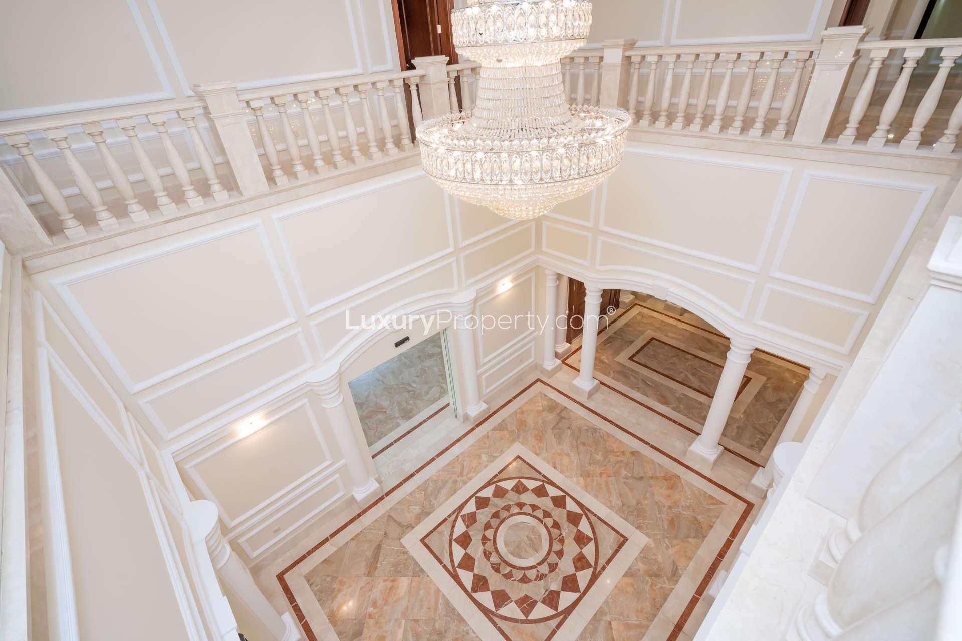 Exquisite Mediterranean villa exterior with palm trees in Emirates Hills, Sector E, for rent