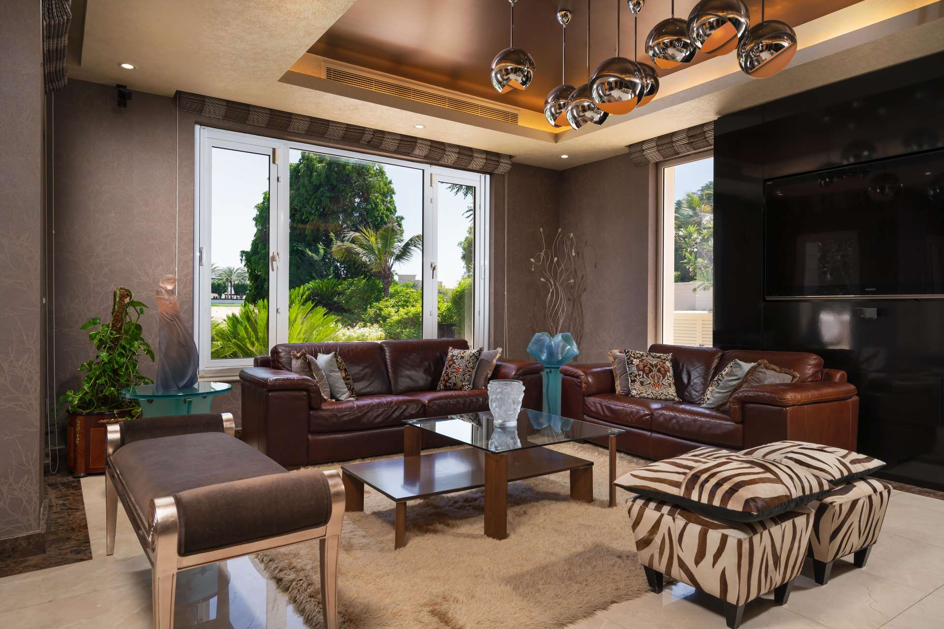 Elegant dining area in 5-bedroom villa, Emirates Hills, featuring luxurious decor and chandelier