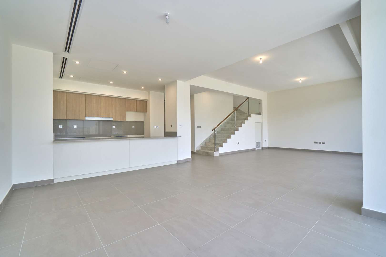 Spacious living area with open kitchen in 5-bedroom villa, Dubai Hills Estate