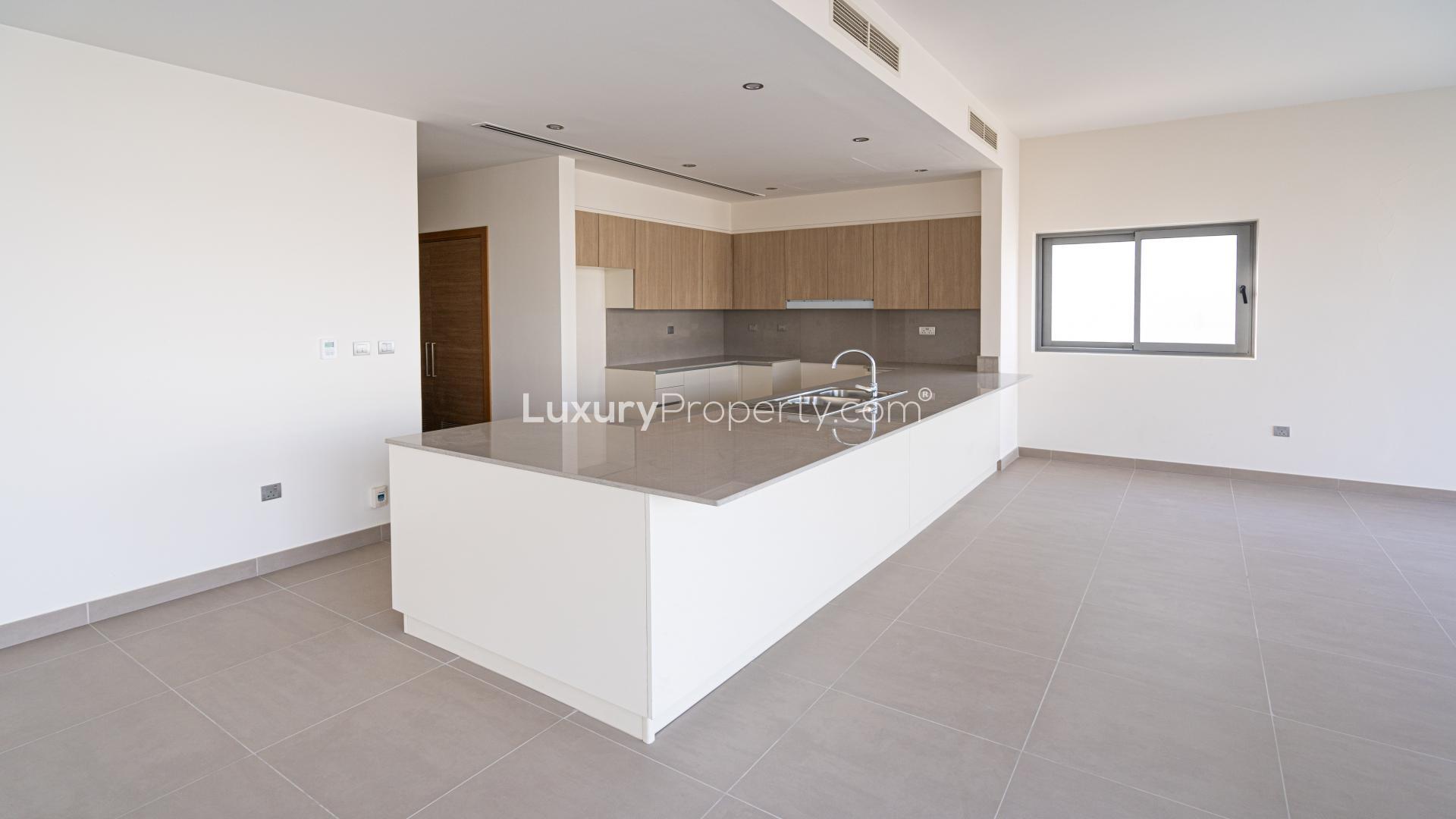 Modern kitchen in Dubai Hills Estate villa, featuring sleek countertops and ample natural light
