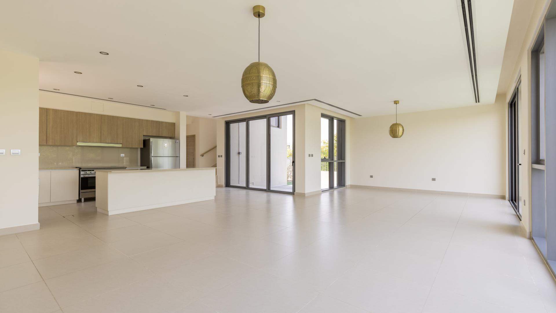 Spacious living room with large windows, garden view in Sidra Villas, Dubai Hills Estate