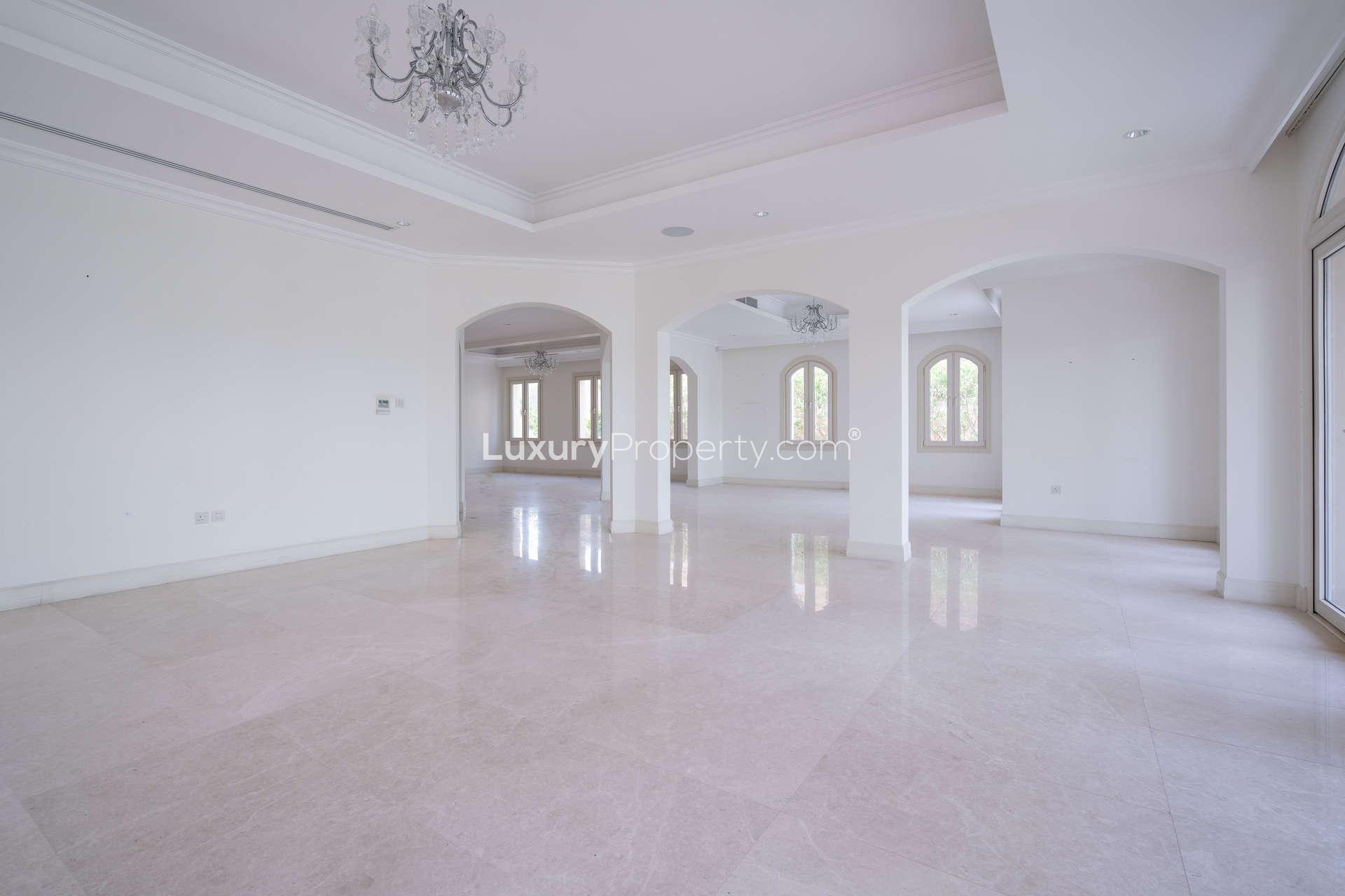 Spacious living area with large windows in Jumeirah Golf Estates villa for rent