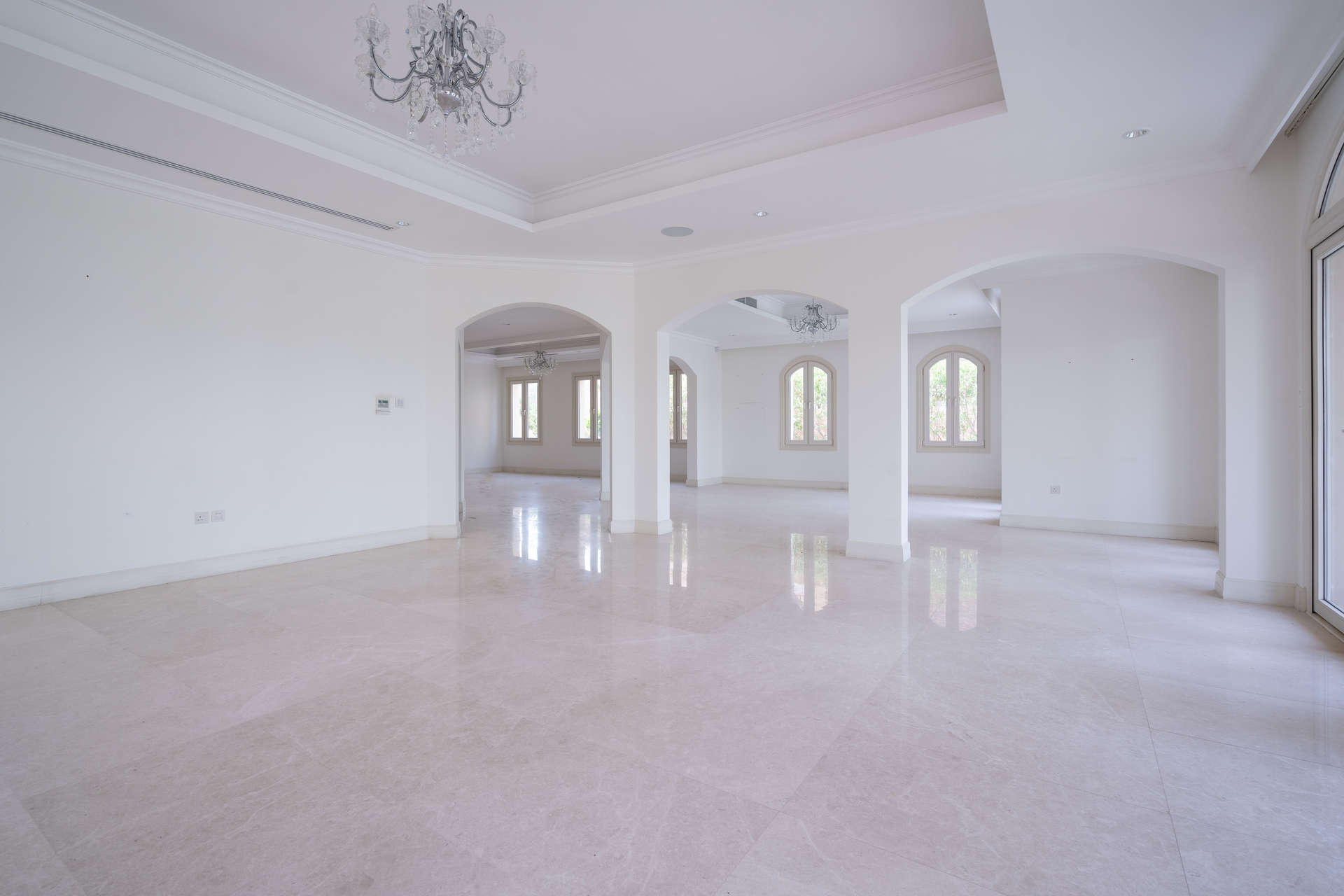 Spacious living area with large windows in Jumeirah Golf Estates villa for rent