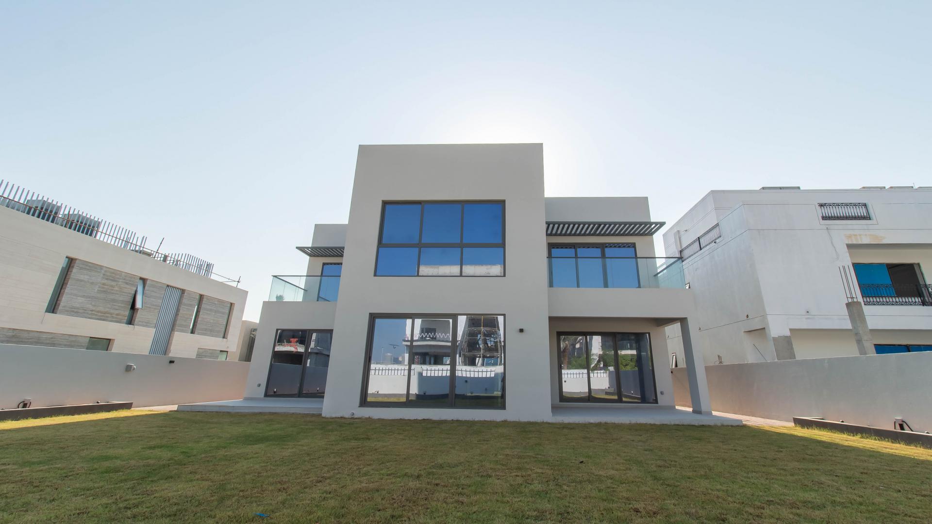 Modern kitchen in 5-bedroom villa, Jumeirah Park, featuring sleek countertops and large windows