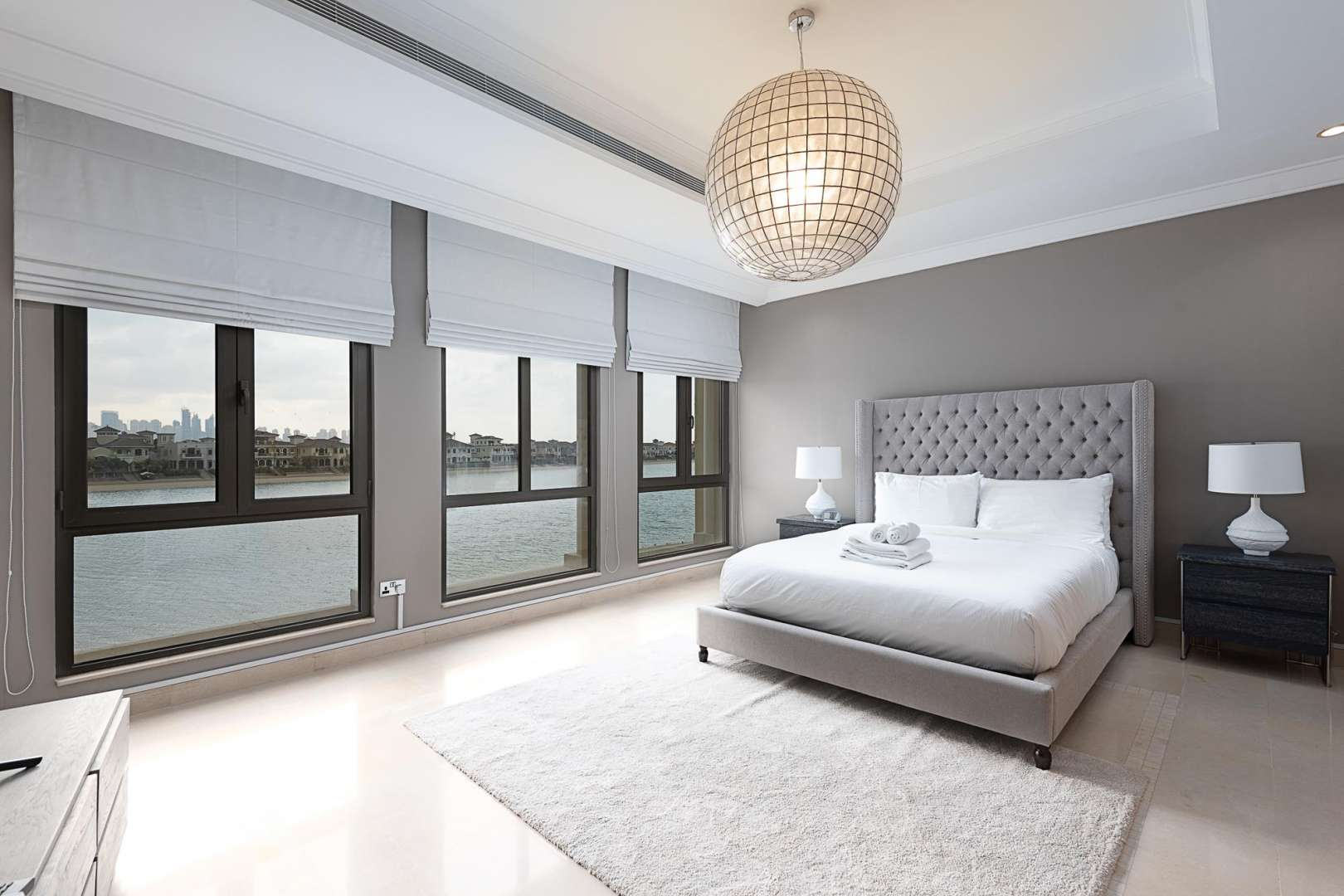 Luxurious bedroom in Mediterranean-inspired villa, Palm Jumeirah, featuring elegant decor and chandelier