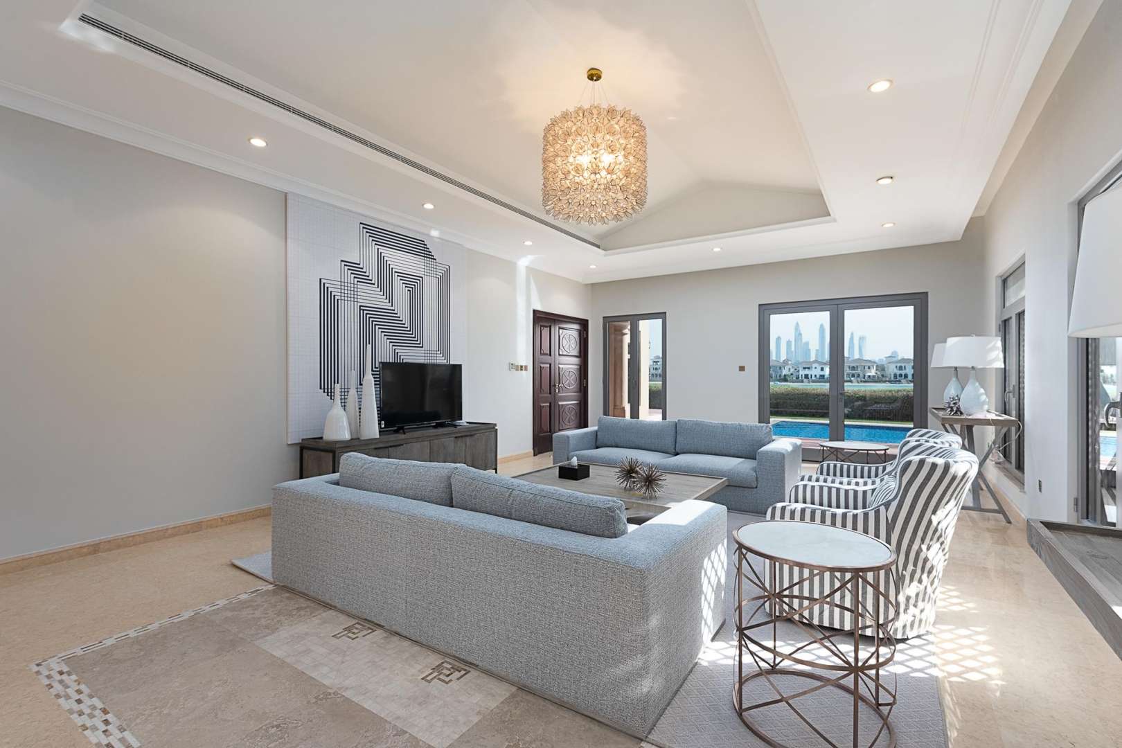 Luxurious living room in Palm Jumeirah villa with modern decor and pool view