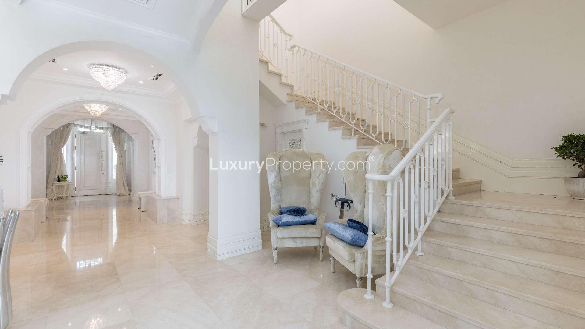 Luxurious hallway in renovated Palm Jumeirah villa with elegant lighting and marble flooring