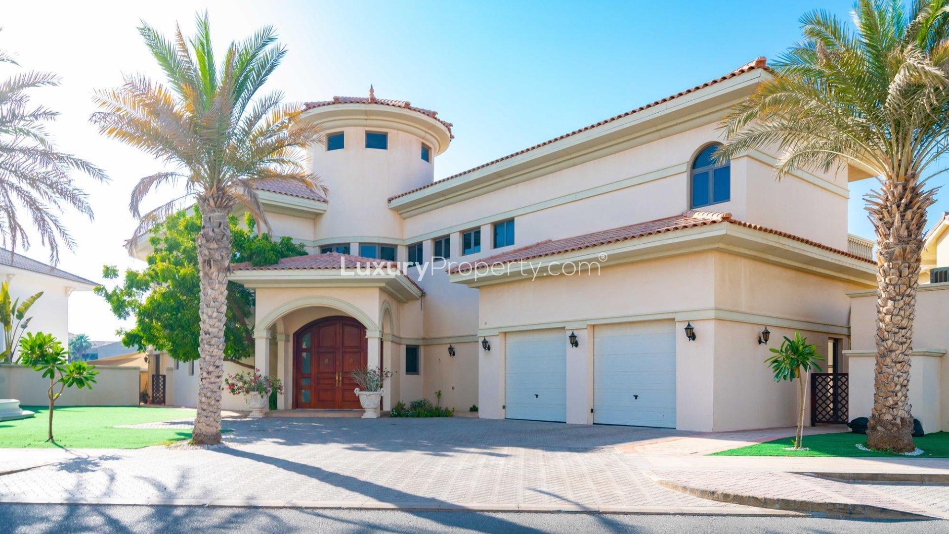 Luxurious living room in Palm Jumeirah Signature Villa with pool view and elegant decor