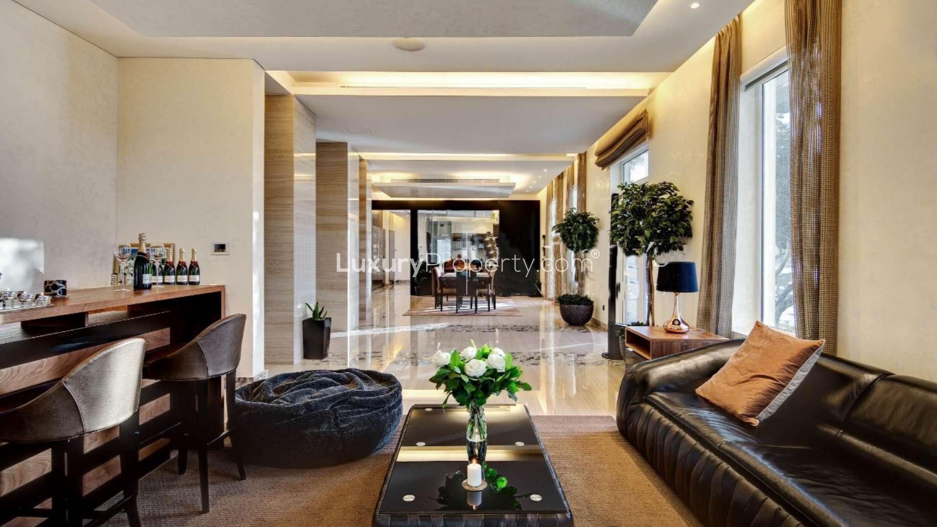 Luxurious entryway in 5-bedroom villa on Palm Jumeirah, featuring elegant chandelier and staircase