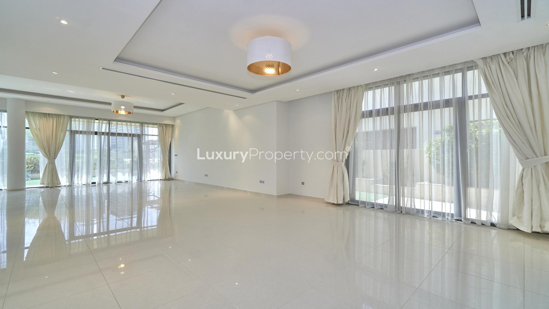 Spacious living area in 5-bedroom Damac Hills villa, Silver Springs, with modern lighting fixtures