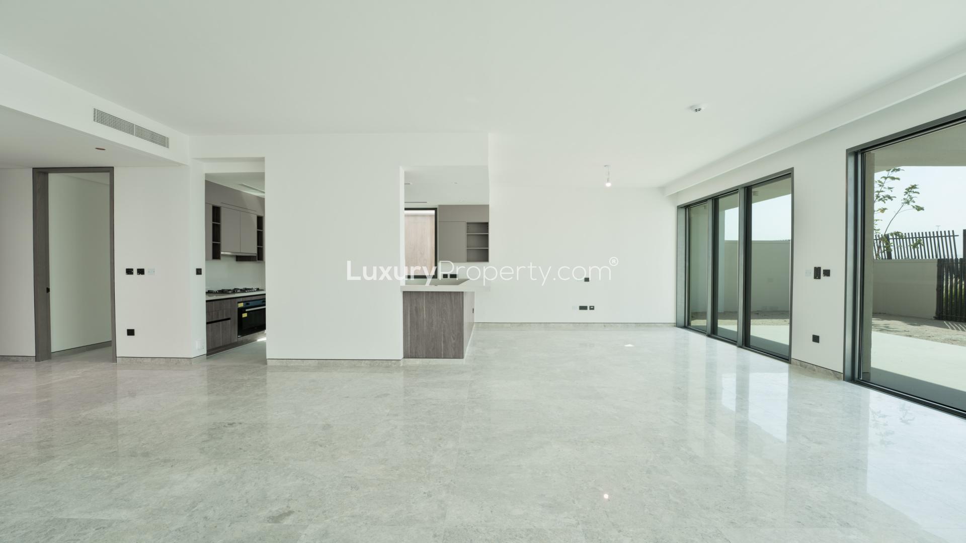Open-plan kitchen and living area with marble floors in Tilal Al Ghaf villa