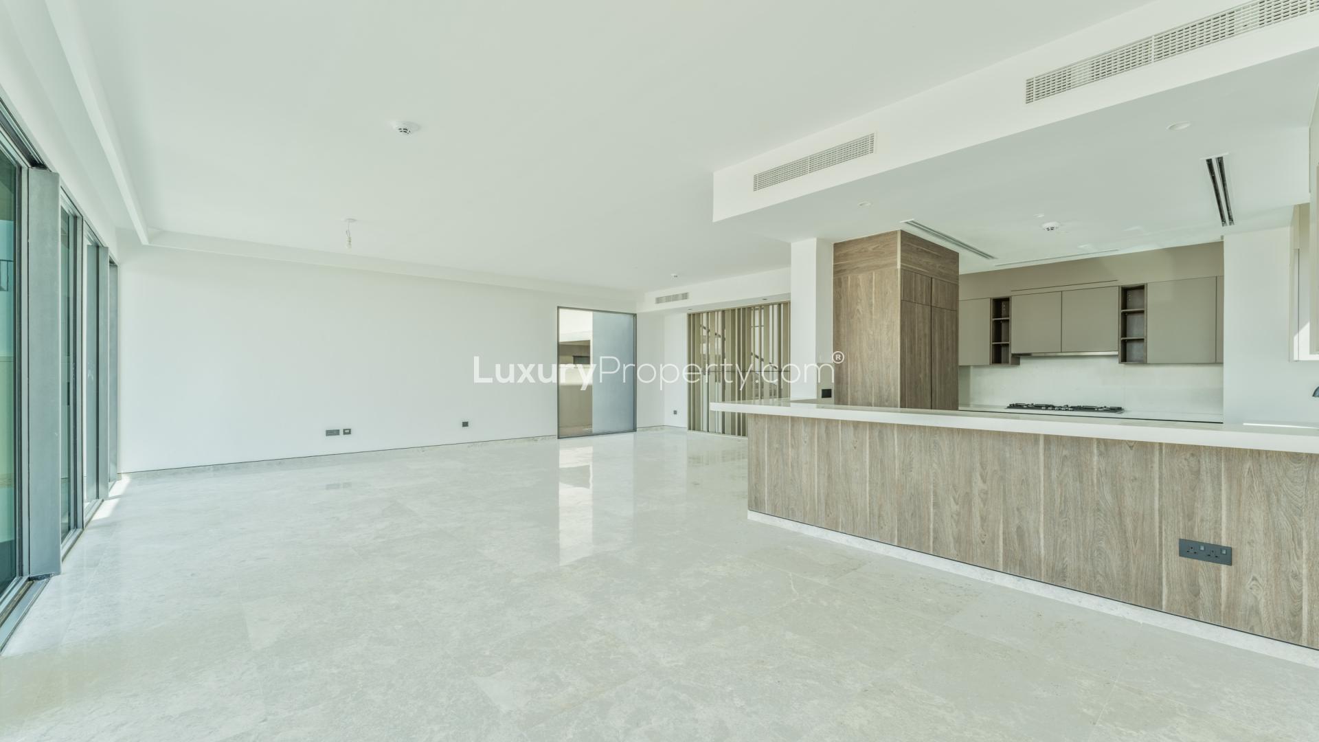Modern 5-bedroom villa exterior in Harmony, Tilal Al Ghaf, featuring spacious driveway and garage