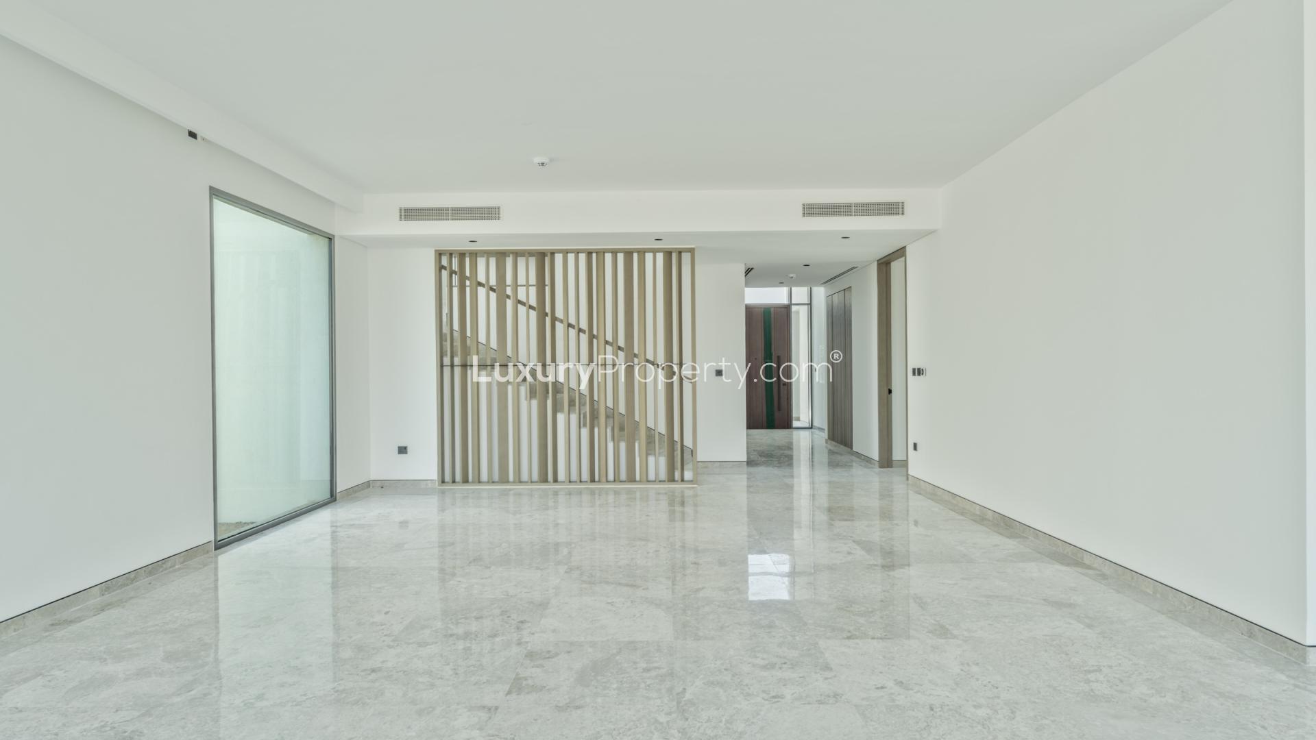 "Spacious villa interior with large glass doors, park view, Tilal Al Ghaf Harmony.",Interior of fully upgraded villa in Harmony, Tilal Al Ghaf, featuring modern design