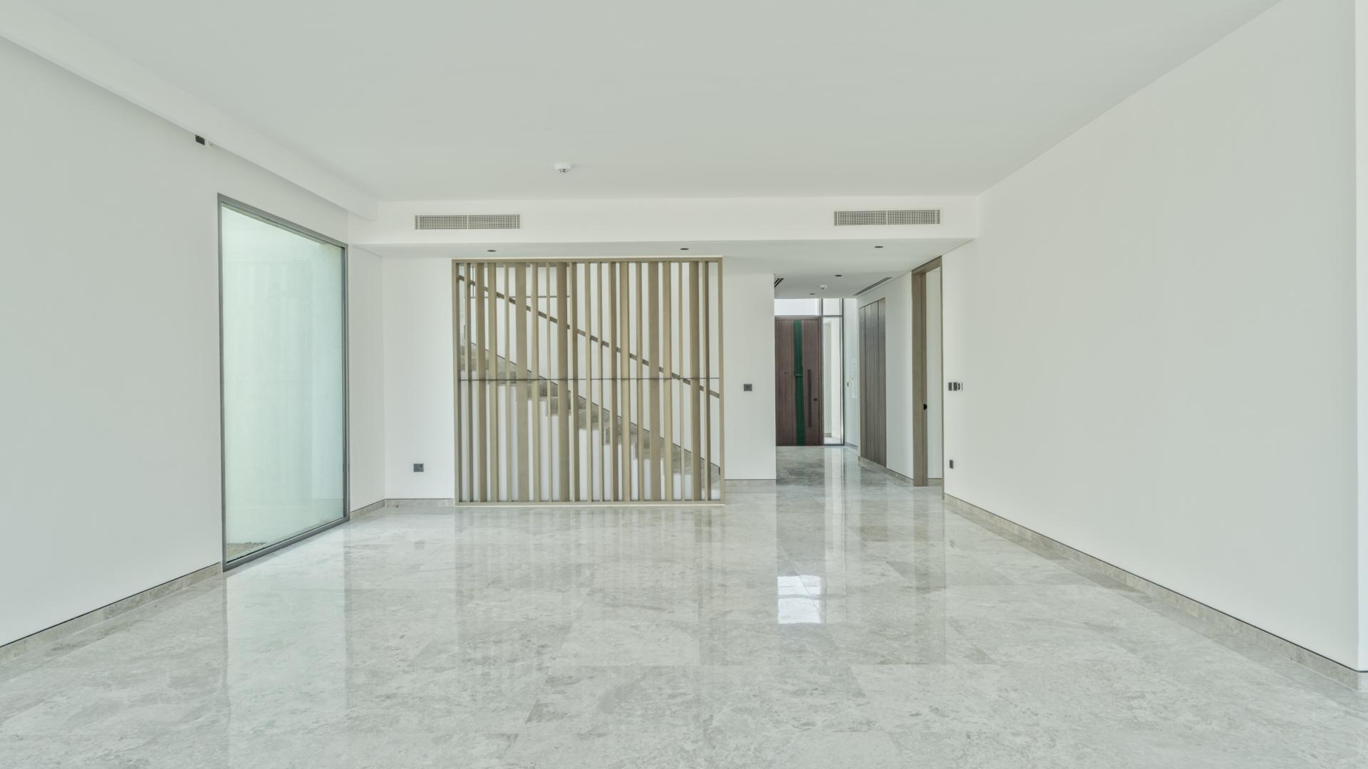 "Spacious villa interior with large glass doors, park view, Tilal Al Ghaf Harmony.",Interior of fully upgraded villa in Harmony, Tilal Al Ghaf, featuring modern design