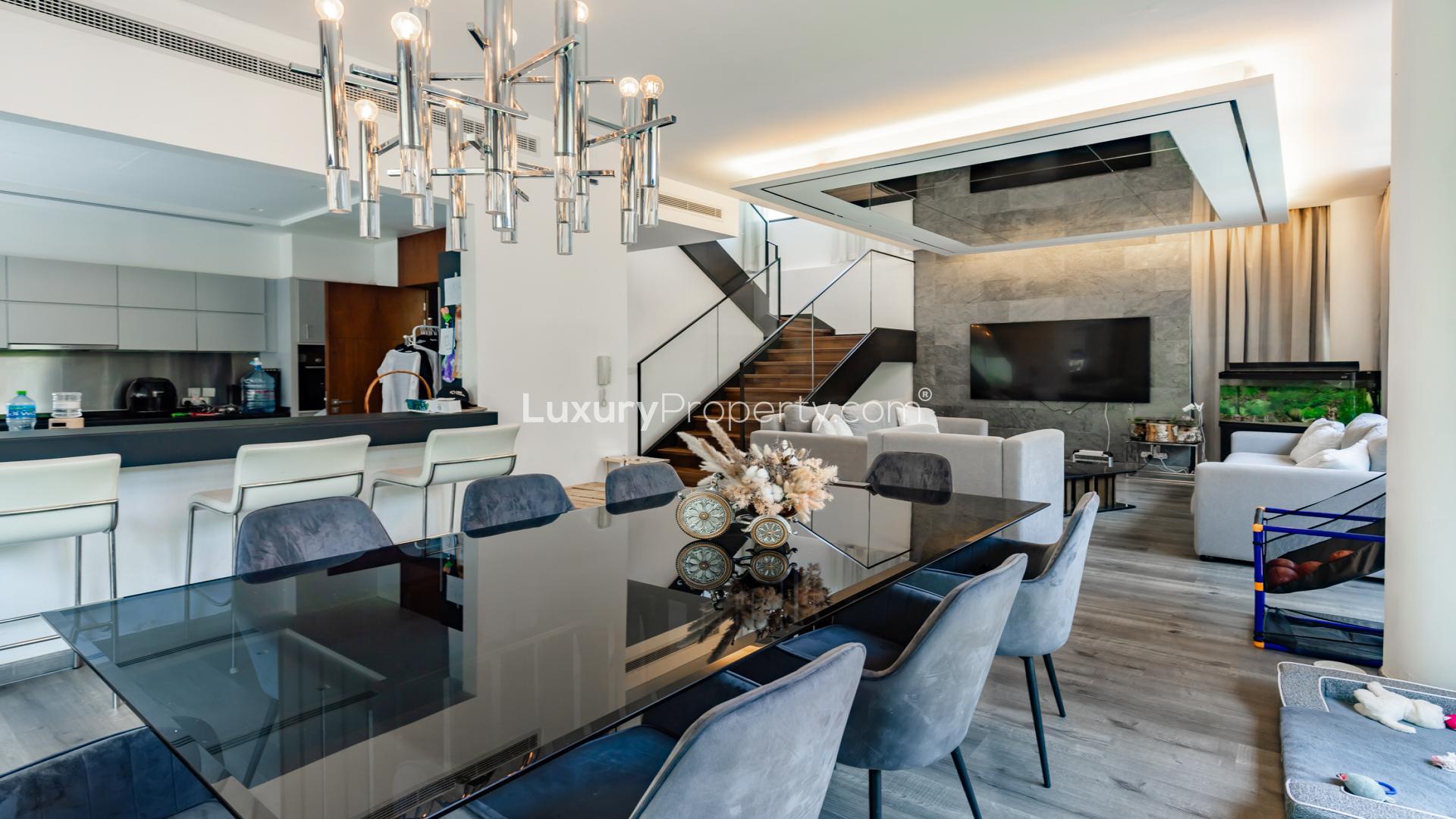Luxury dining area in 5-bedroom villa, Piccadilly Green, Damac Hills, with garden view