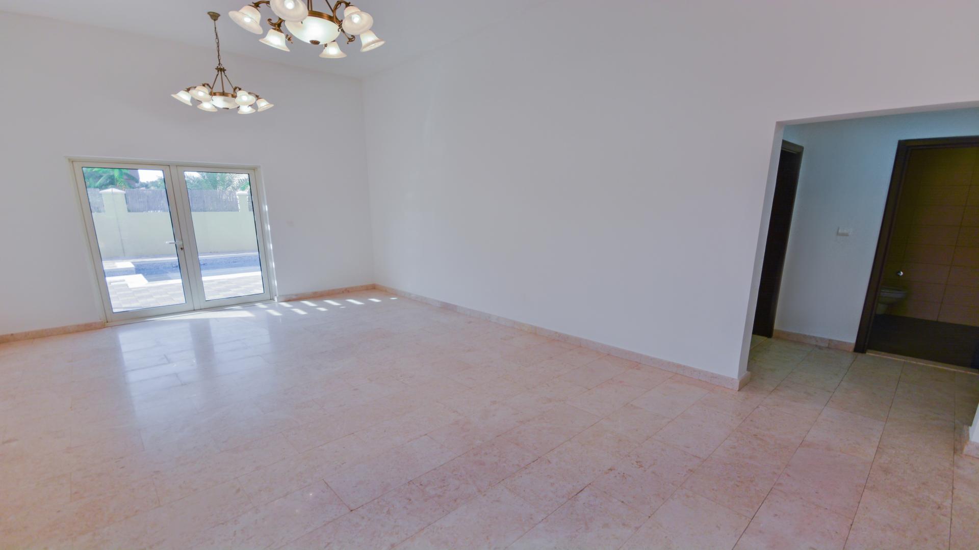 Spacious villa interior with marble floors and staircase in The Aldea, The Villa community