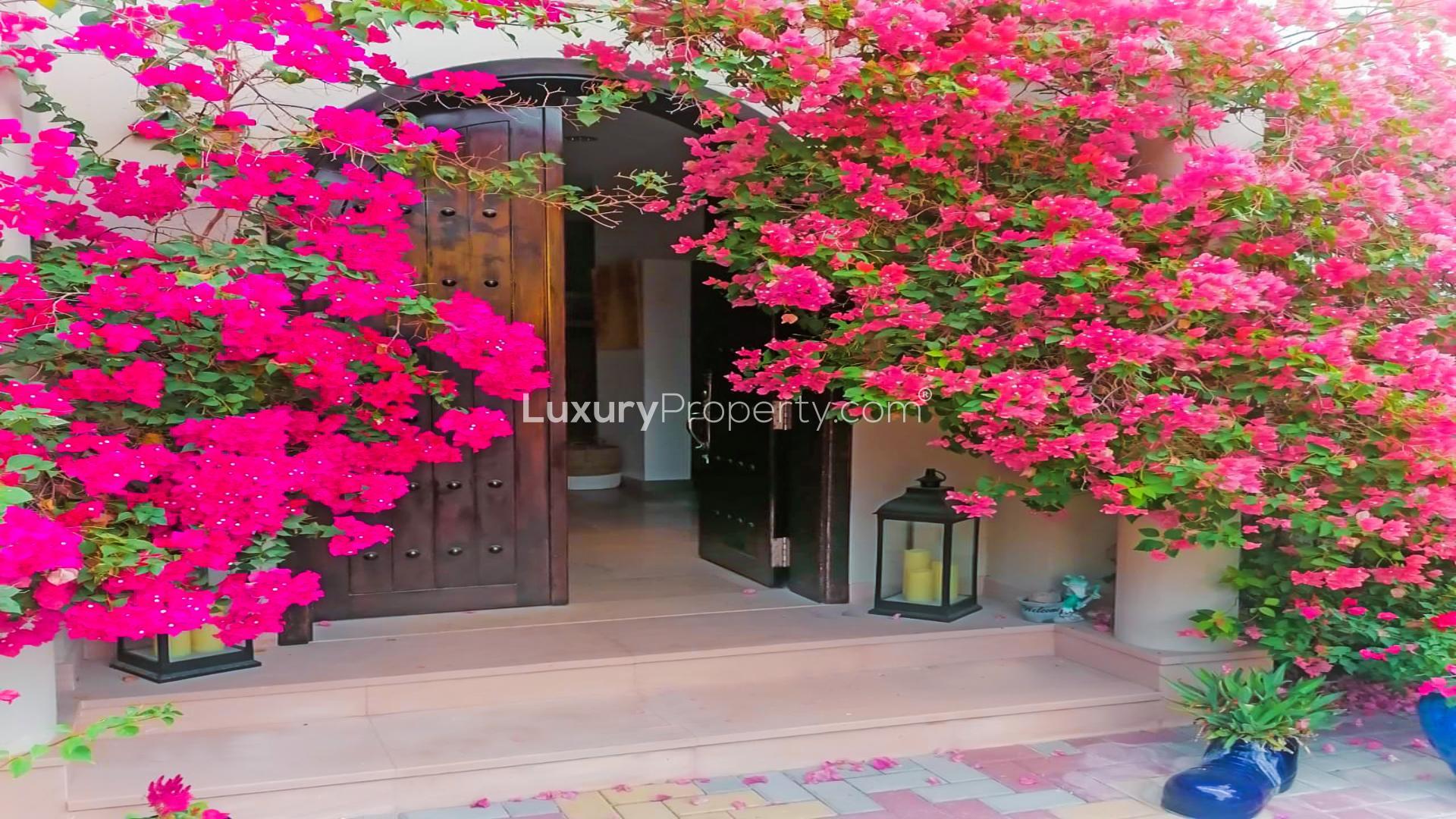 Outdoor seating area by private pool in custom-built villa, The Aldea, The Villa community