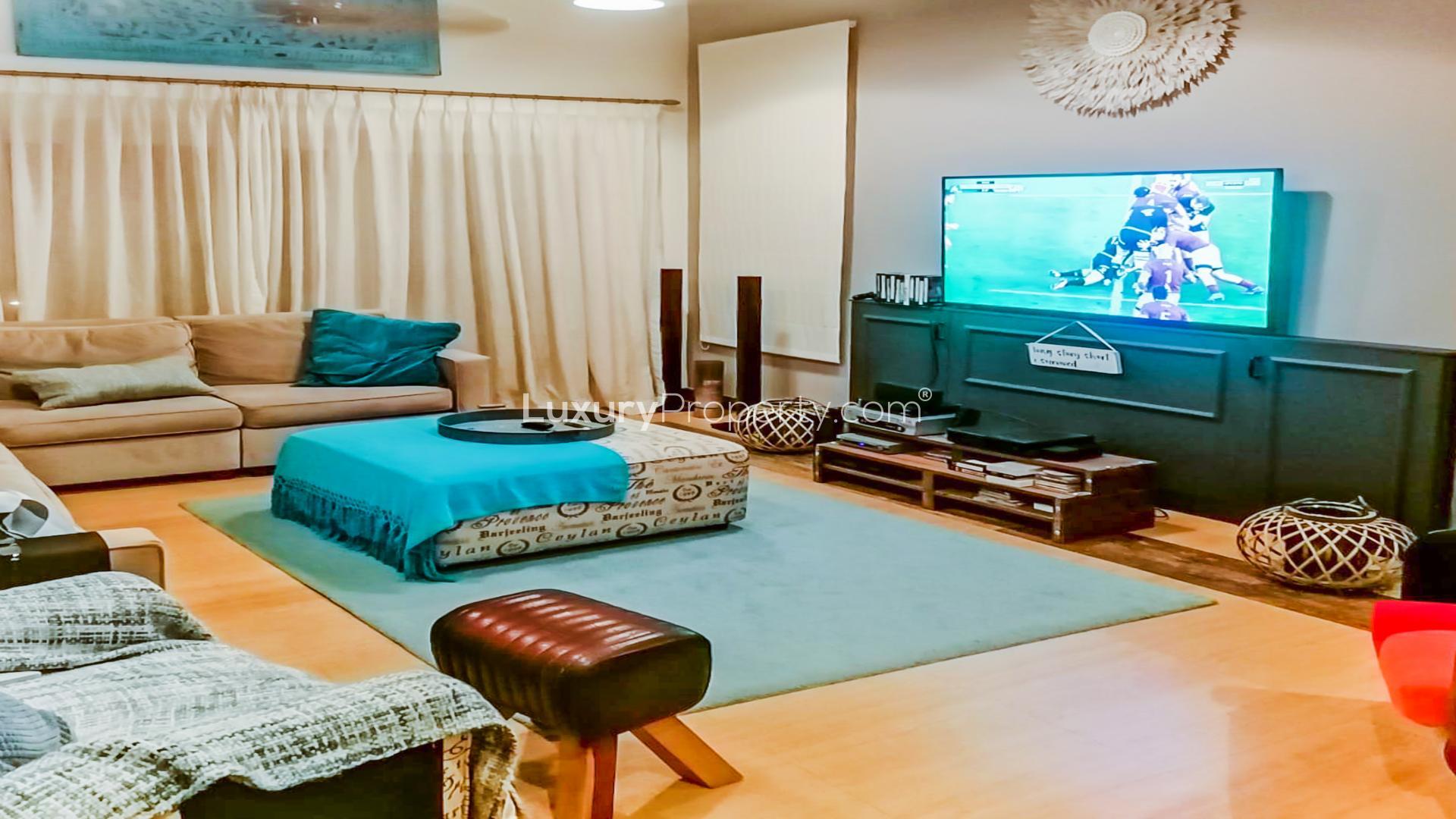 Entrance of custom-built villa with vibrant bougainvillea in The Aldea, The Villa